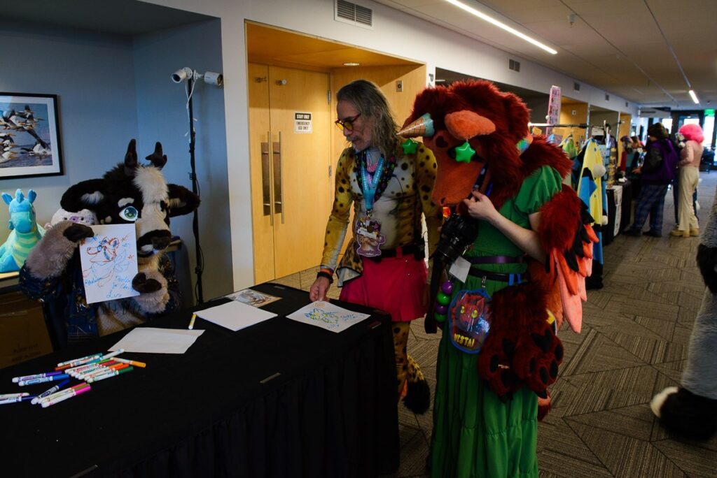Pnderosas in fursuit being our doodler, making doodles for charity while Cheetaro and Vestai.derg watch. 