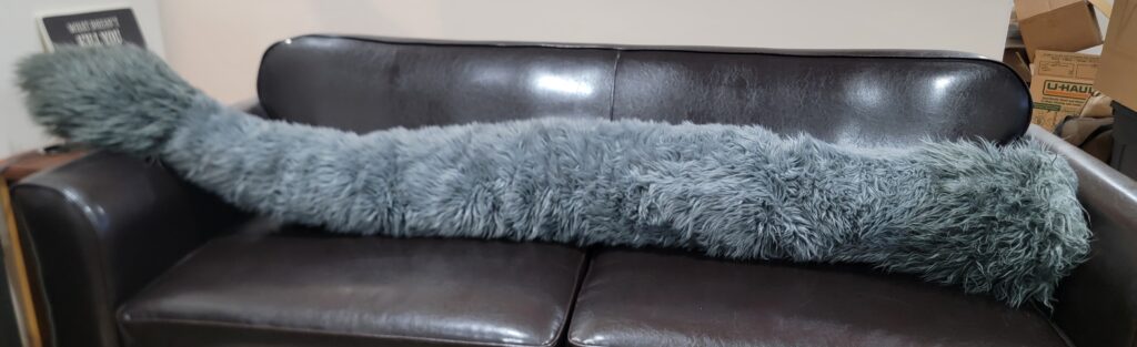 A seven foot long grey fursuit tail.