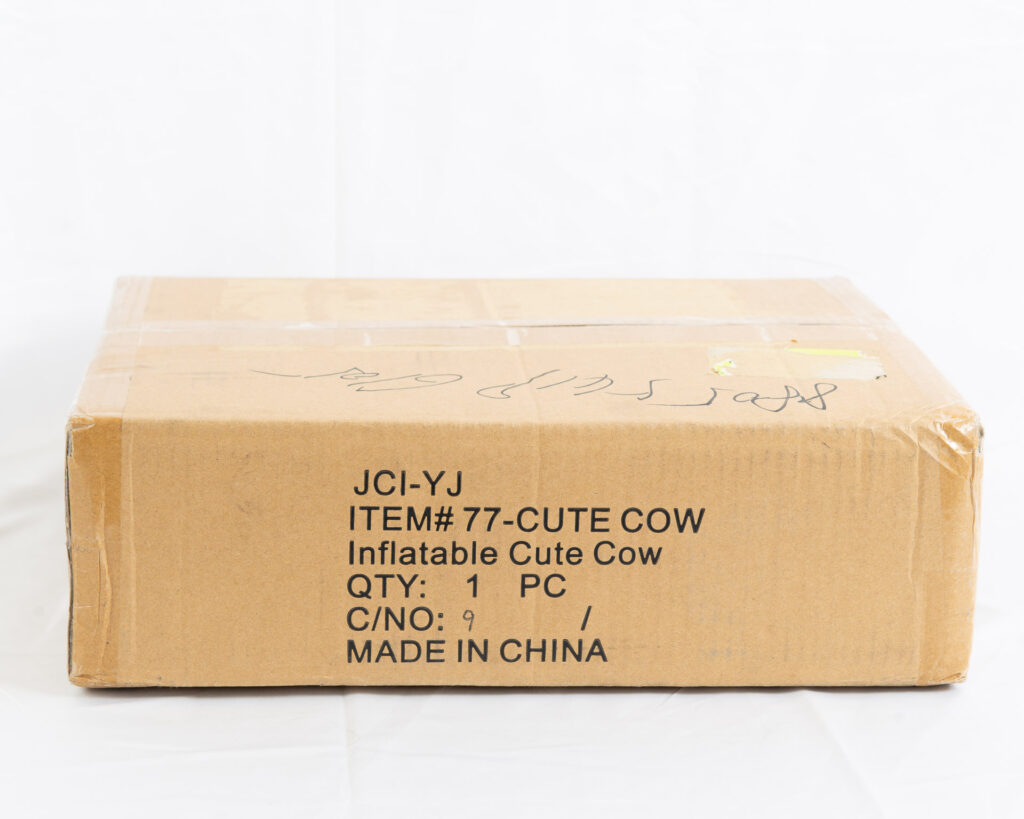 A box labeled inflatable cute cow, containing a new in box inflatable cute cow by Jet Creations